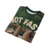 Dark green foliage and brown tree branches cover this full print shirt, featuring two sloths hanging and the text