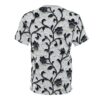 Black floral vines and flowers with glossy texture cover this textured white background shirt.