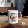 White mug with pink handle and rim, featuring a cute sloth in a hammock saying 