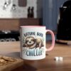 A white ceramic coffee mug with a pink interior and handle, featuring a cute sloth illustration.
