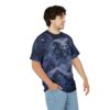 Dark blues, purples, and hints of yellow swirl around a menacing demon with glowing eyes and sharp horns on this graphic t-shirt.