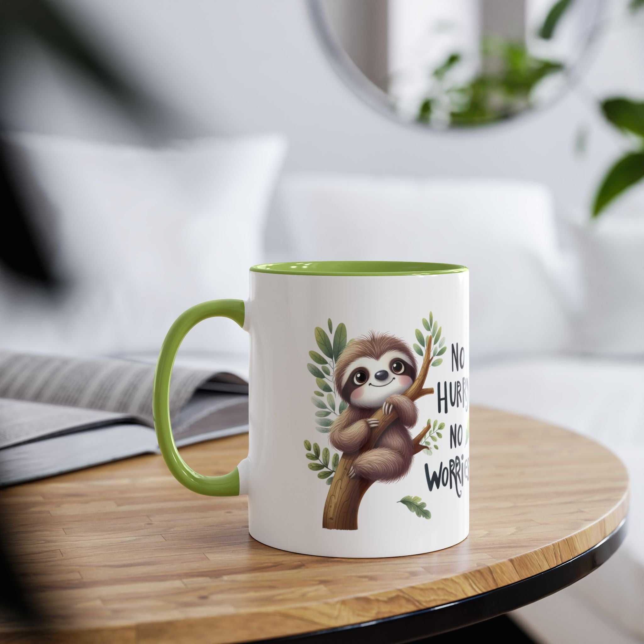 White ceramic mug with a green rim and handle, featuring a cute sloth hanging from a branch with the text "No Hurry, No Worry".