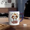 White ceramic coffee mug with a blue handle, featuring a cute sloth peeking out of a carved pumpkin with the words 