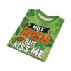 Vibrant green shamrocks and a bold kiss graphic cover this oversized full print tee, featuring the text 