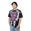 White and black sunburst patterns cover this 3D graphic t-shirt, featuring a close-up of a purple, wide-grinning devil in a suit.