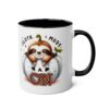 White ceramic mug with black interior and handle, featuring a cute sloth peeking out of a pumpkin with 