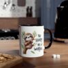 White ceramic mug with black handle and rim, featuring a cute sloth illustration and