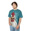 Teal with white speckles and radiating lines cover this oversized full print tee, featuring a cartoon chicken with wide eyes and a gaping mouth.