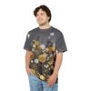 Golden and white circular floral motifs with delicate brown stems on a dark grey textured background cover this tee.