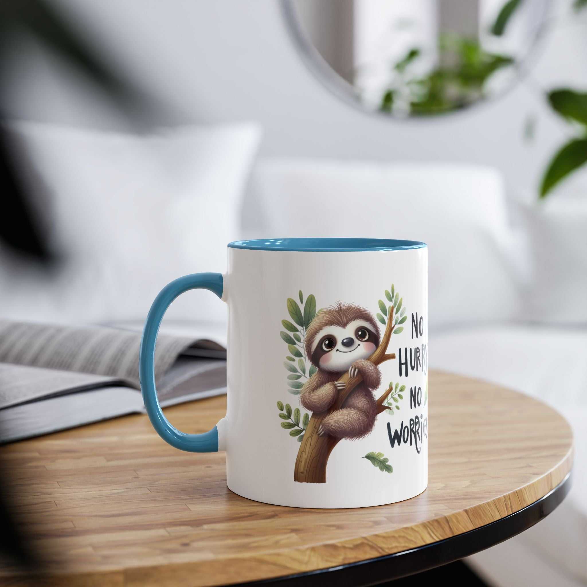 White mug with blue rim and handle, featuring a cute sloth on a branch with leaves and text.