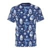 White and blue ornate Easter eggs and blooming flowers cover this dark blue patterned tee shirt, with floral stems and leaves.
