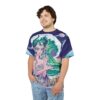 Vibrant blues, greens, and purples cover this seamless pattern tee, depicting a mystical creature with horns against a cosmic ocean wave.