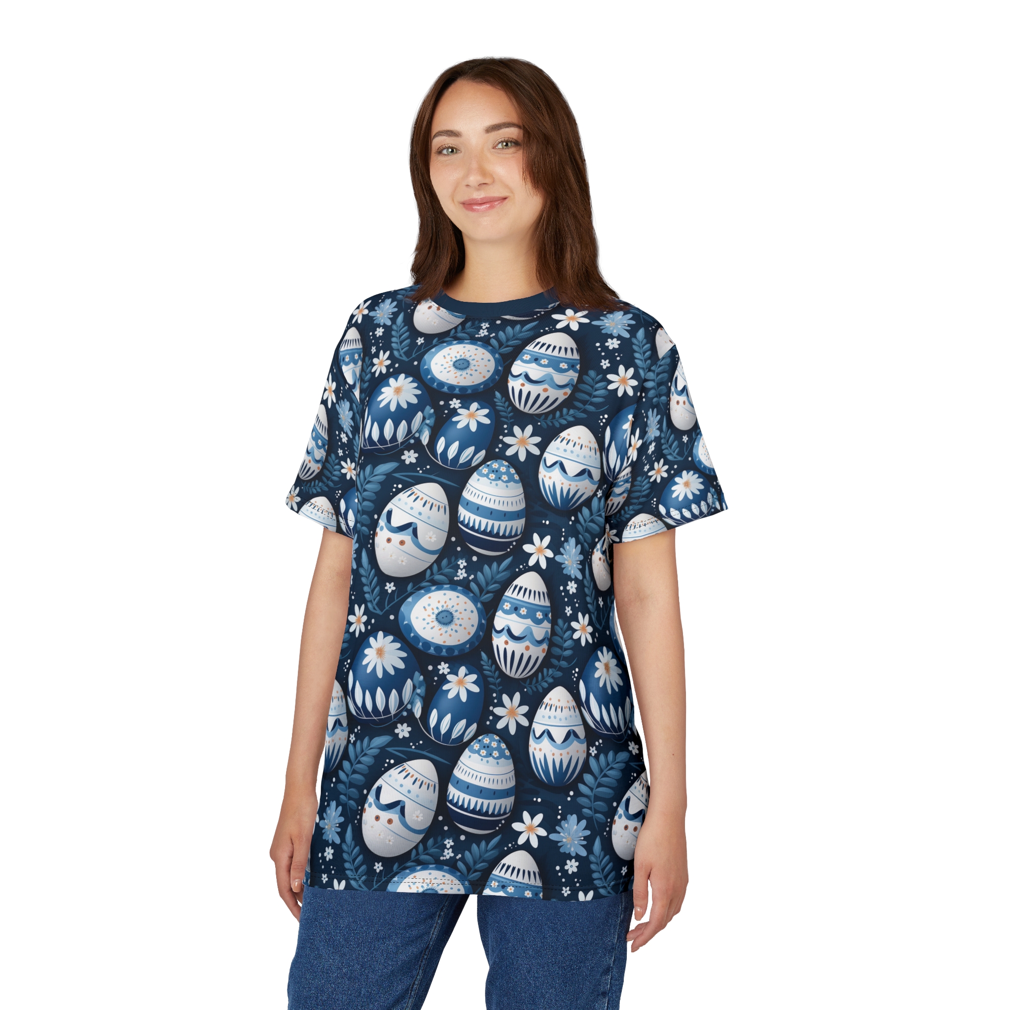 Blue and white patterned Easter eggs and small flowers cover this seamless pattern tee, with blue leaves and branches as background elements.