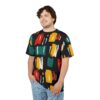 Bold red, yellow, teal, and cream brushstrokes cover this all over print t-shirt, creating a dynamic abstract pattern on a black background.