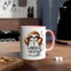 White coffee mug with pink handle and rim, featuring a cute sloth peeking out of a coffee cup with text that reads 