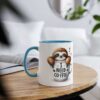 A white coffee mug with a blue rim and handle features a cartoon sloth peeking out of a coffee cup that says 
