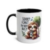 White mug with black handle and interior, featuring a cute sloth and text 