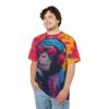 Bold pink, yellow, and blue paint splatters cover this patterned tee shirt, featuring a cool ape with headphones and sunglasses.