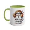 White coffee mug with a green interior and handle, featuring a cute sloth peeking out of a coffee cup that says 