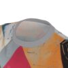 Abstract shapes in orange, grey, teal, and pink cover this sublimation graphic tee, with painted textures and dark lines.