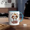 White mug with a blue handle, featuring a cute sloth peeking out of a white pumpkin, with 