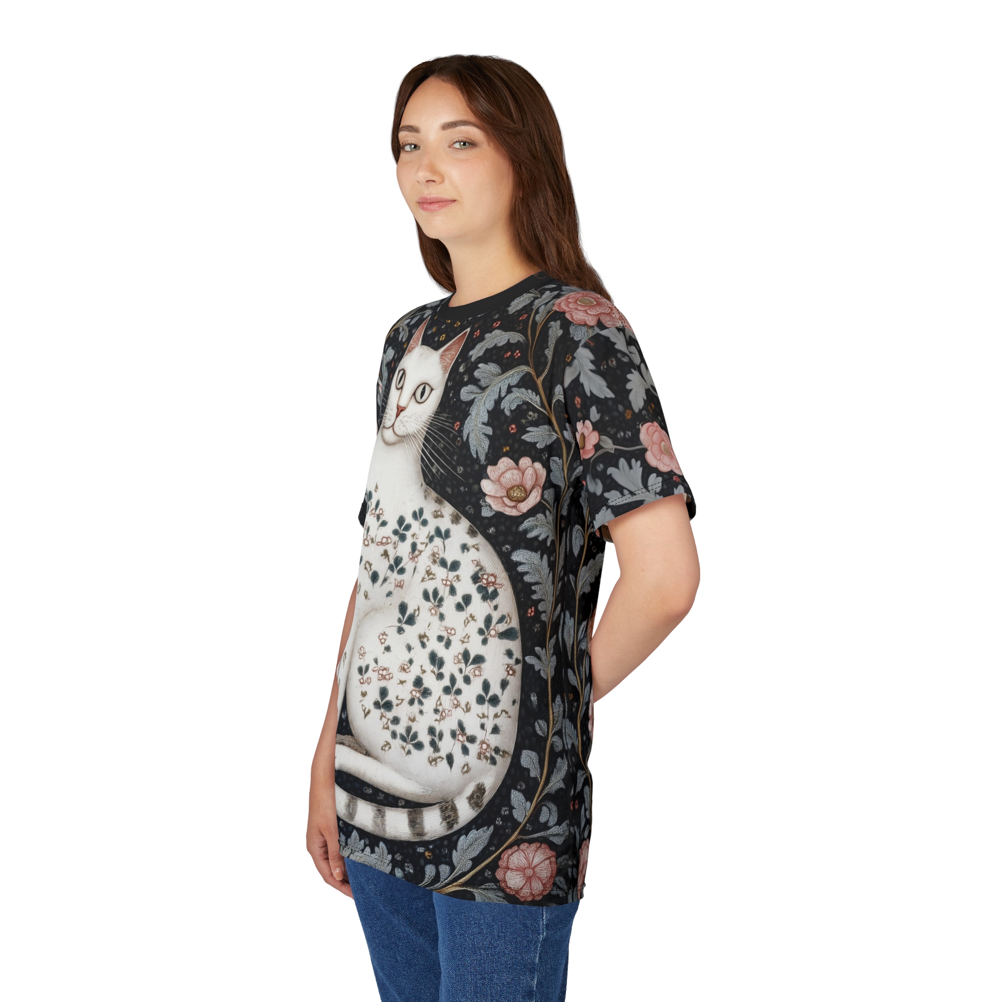 Black fabric with dark floral patterns, pink flowers, and a white cat covered in small leaves adorn this patterned tee shirt.
