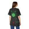 Dark metallic textures with glowing green and red circuit patterns cover this patterned tee shirt, depicting a futuristic mechanical core.