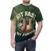 Deep green foliage and branches cover this oversized full print tee, depicting a smiling sloth hanging from a branch with 