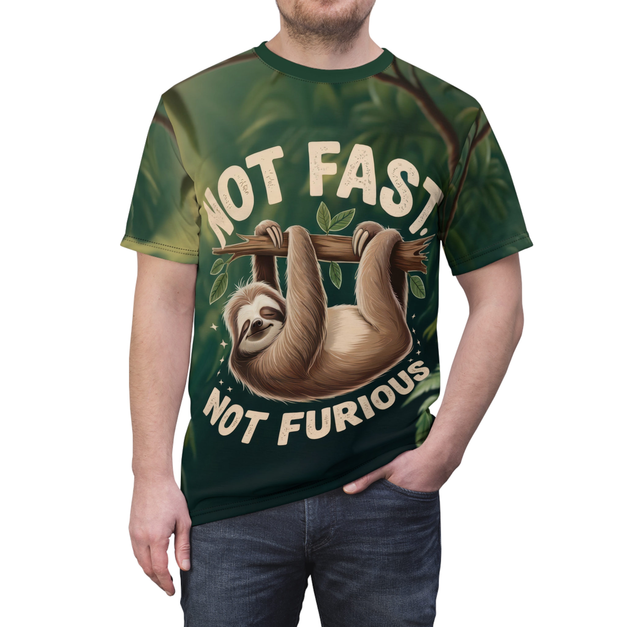 Deep green foliage and branches cover this oversized full print tee, depicting a smiling sloth hanging from a branch with "NOT FAST - NOT FURIOUS" text.