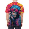 Bright pink, blue, and yellow paint splatters cover this all over print apparel, featuring a chimpanzee wearing headphones and sunglasses.