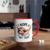 White ceramic mug with a red handle and rim, featuring a sloth in a hammock with the text 
