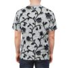 Impasto textured light grey fabric with raised black floral vines and dark blooms covers this oversized full print tee, creating a tactile and dramatic visual.