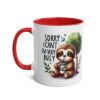 White ceramic mug with a red interior and handle, featuring a cute sloth illustration that says 