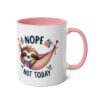 White ceramic mug with a pink interior and handle, featuring a cute sloth in a hammock with 