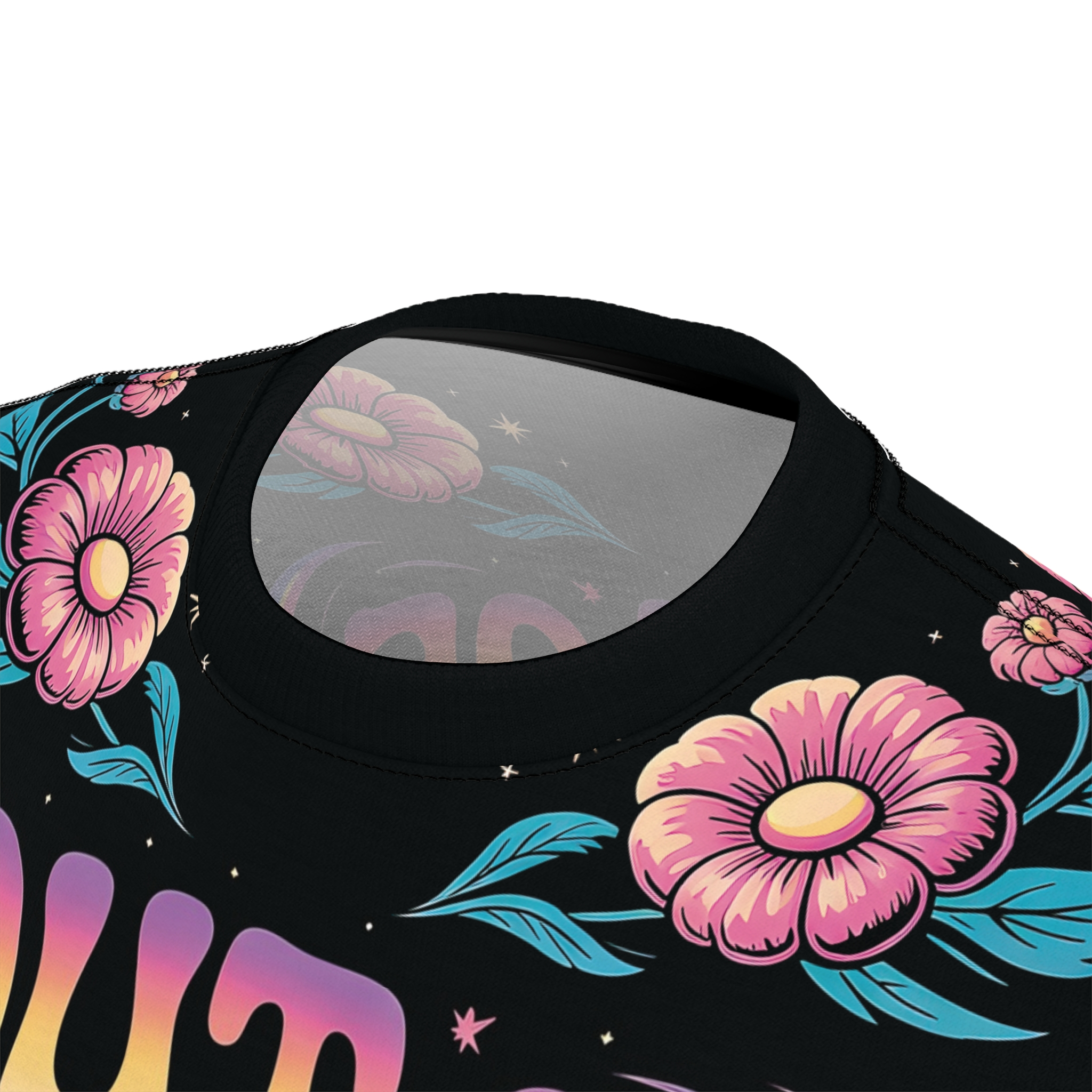 Pink and yellow flowers with teal leaves and starry accents cover this sublimation graphic tee, with wavy, pastel lettering appearing beneath.