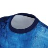 Close-up of a t-shirt with an abstract blue brushstroke pattern, focusing on the neckline.