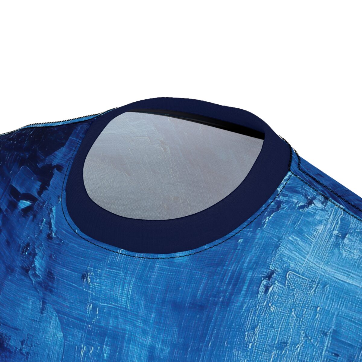 Close-up of a t-shirt with an abstract blue brushstroke pattern, focusing on the neckline.