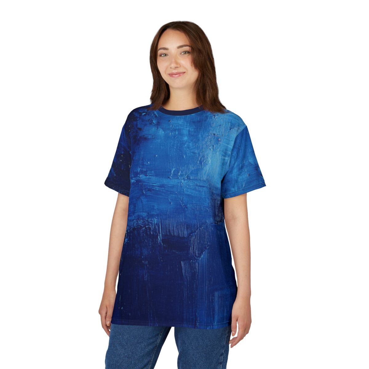 Rich blues and textured brushstrokes cover this patterned tee shirt, evoking an abstract ocean scene.