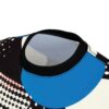 Black, white, and blue shapes, polka dots, and a checkered pattern cover this patterned tee shirt, with abstract skull imagery throughout.