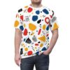 White crewneck t-shirt covered in a vibrant abstract pattern of red, blue, and yellow shapes with black accents.