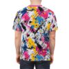 This all-over print t-shirt features a dynamic abstract design with white, black, bright pink, royal blue, and vibrant yellow paint splatters and drips across the fabric.