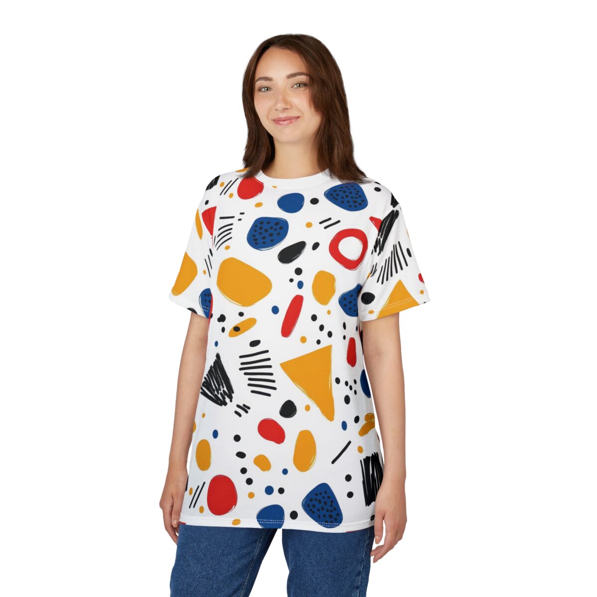 Red, yellow, blue, and black abstract shapes and lines cover this all over print t-shirt, with scattered dots and a ring design.