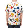 Red, blue, yellow, and black abstract shapes, dots, and scribbles cover this sublimation graphic tee.