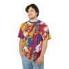 Vibrant t-shirt featuring an energetic abstract paint splatter design with bold reds, blues, and yellows against a white base.