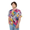 Bright pink, yellow, and blue paint splatters cover this graphic streetwear tee, with black lines and white accents.