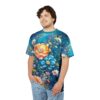 Vibrant blue and green hues with large orange and blue blossoms, small white flowers, and delicate branches cover this graphic streetwear tee.