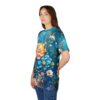 Vivid blue, orange, and pink blossoms with green leaves and glowing accents cover this patterned tee shirt, depicting a fantastical garden scene.