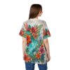 Floral all over print sublimation tee featuring vibrant red and orange flowers with lush green foliage on a light background.
