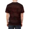Deep red and brown textured patterns cover this patterned tee shirt, featuring spooky black tree branches and flying bats with glowing yellow eyes.