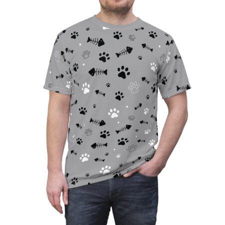 Black and white paw prints and fish skeletons cover this grey all over print t-shirt, scattered with small white dots.